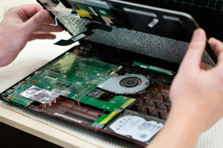 Technician repairing a laptop in the service centre